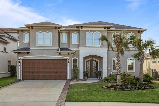 view of front of house with a garage, french doors, and a front lawn