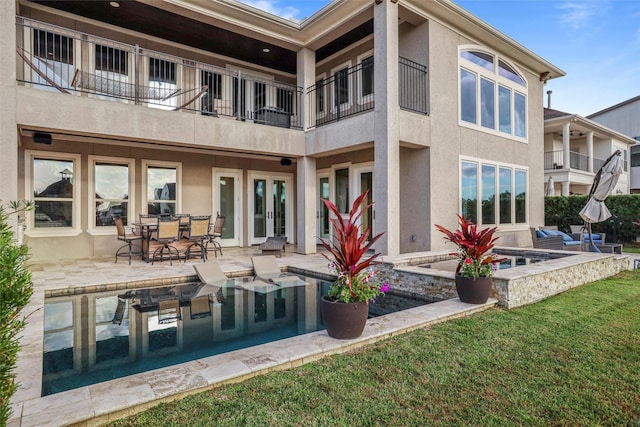 back of property with a patio and a balcony