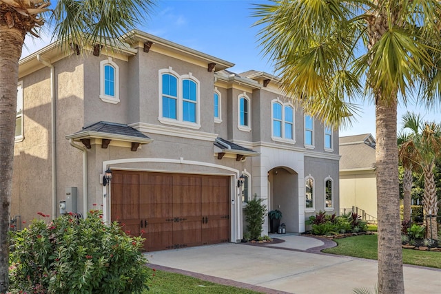 mediterranean / spanish-style house with a garage