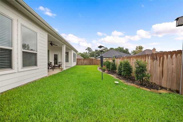 view of yard with a patio and ceiling fan