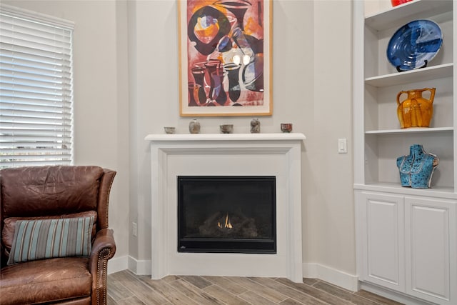 living area featuring plenty of natural light and light hardwood / wood-style flooring