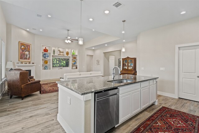 kitchen with white cabinetry, dishwasher, sink, decorative light fixtures, and a kitchen island with sink