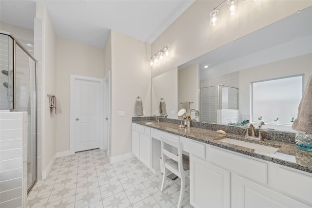 bathroom with vanity and a shower with door