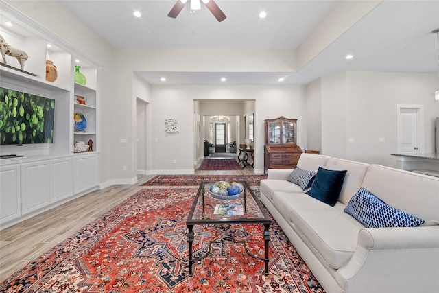 living room featuring ceiling fan and light hardwood / wood-style floors