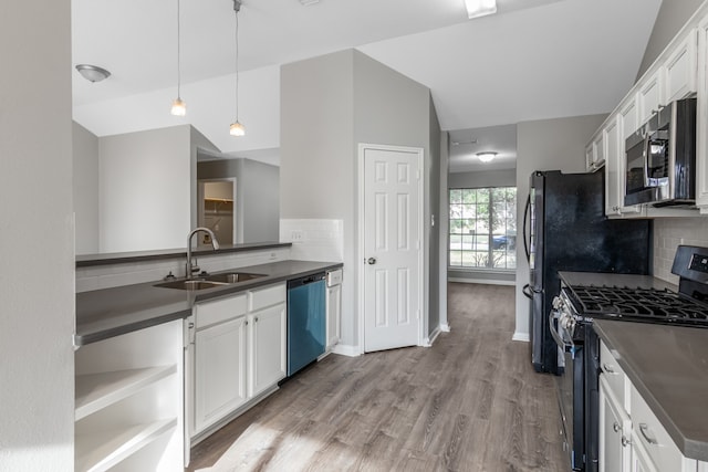 kitchen featuring backsplash, stainless steel appliances, sink, pendant lighting, and white cabinetry