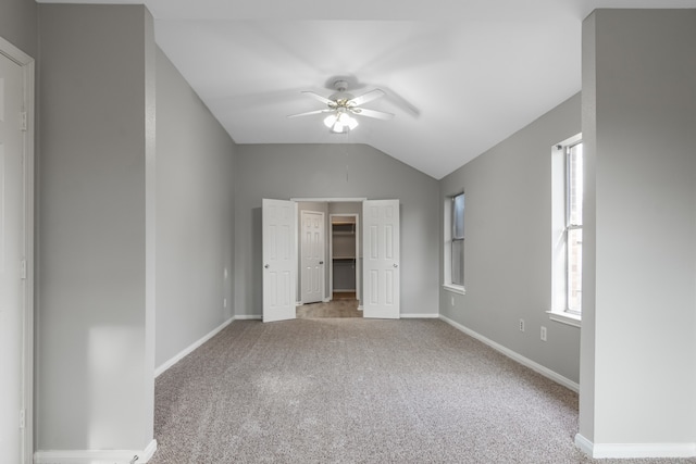 unfurnished bedroom featuring ceiling fan, carpet floors, and vaulted ceiling