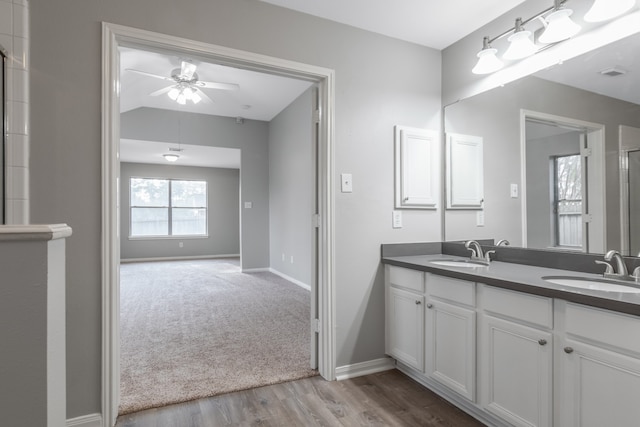 bathroom featuring hardwood / wood-style floors, ceiling fan, and vanity