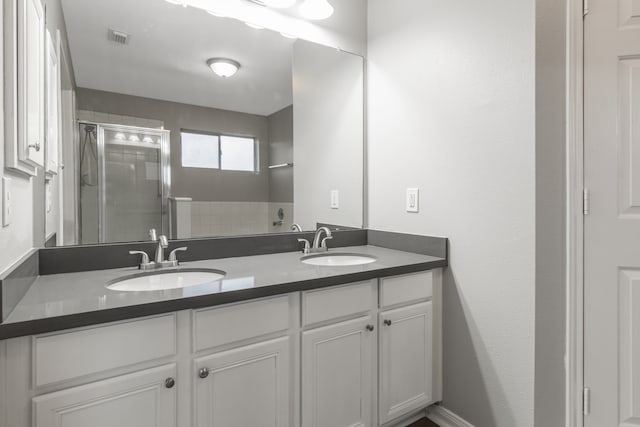 bathroom featuring vanity and an enclosed shower