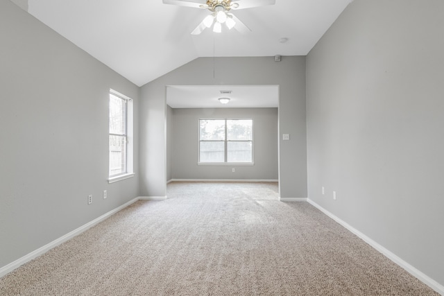 empty room with ceiling fan, light carpet, and lofted ceiling