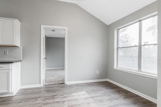 interior space with light hardwood / wood-style flooring and lofted ceiling