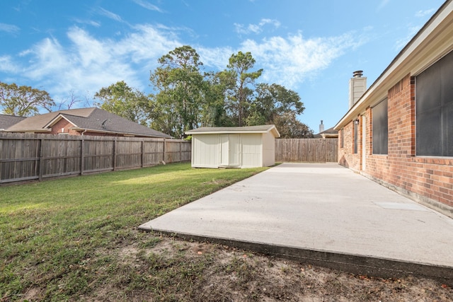 view of yard with a storage unit and a patio area