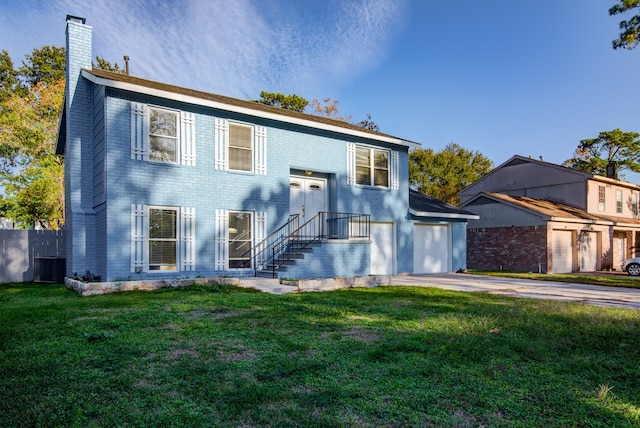 view of front of home with central AC unit, a garage, and a front yard