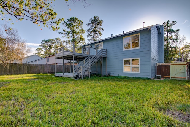 back of house with a yard and a deck