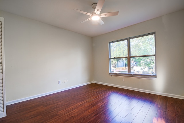 spare room with dark hardwood / wood-style floors and ceiling fan