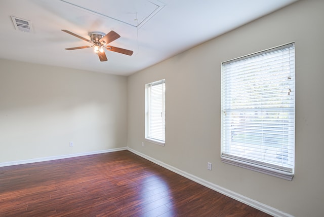 spare room with ceiling fan and dark wood-type flooring