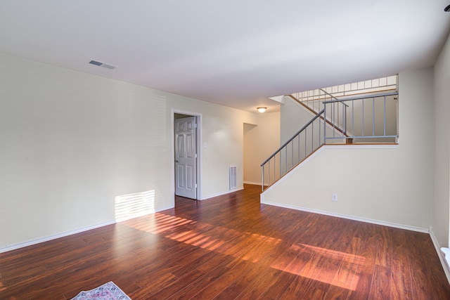 spare room featuring dark wood-type flooring