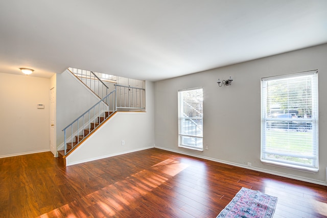 unfurnished living room featuring dark wood-type flooring