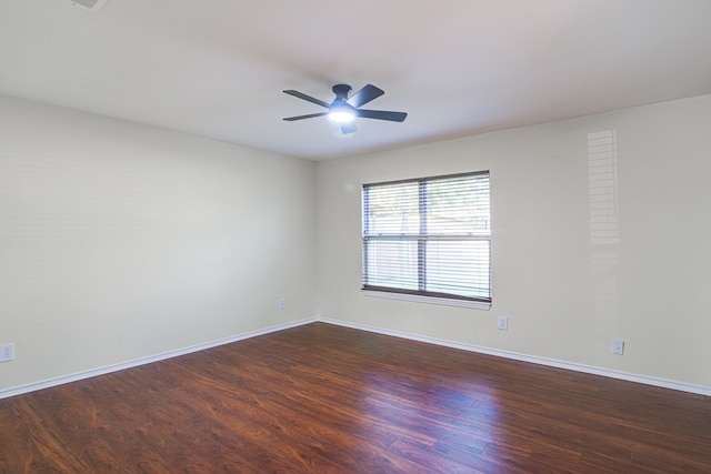 spare room featuring ceiling fan and dark wood-type flooring