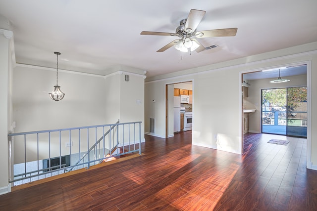 empty room featuring ceiling fan, dark hardwood / wood-style flooring, and crown molding