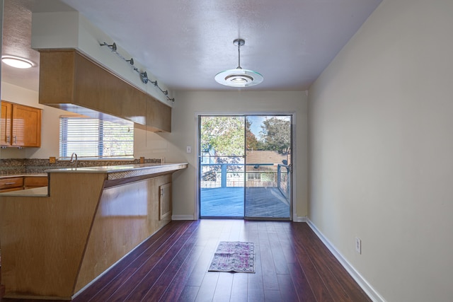 kitchen with track lighting and dark hardwood / wood-style floors