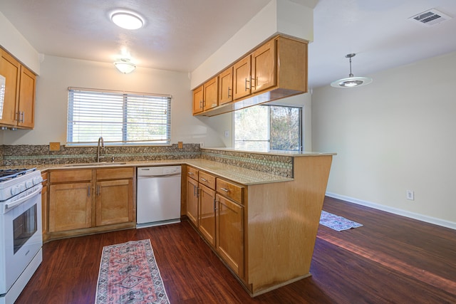 kitchen featuring kitchen peninsula, dark hardwood / wood-style flooring, white appliances, and sink