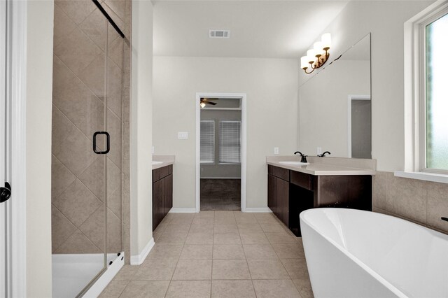 bathroom featuring shower with separate bathtub, vanity, tile patterned floors, and plenty of natural light