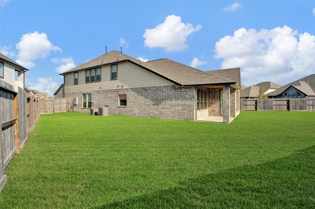 rear view of property featuring a yard