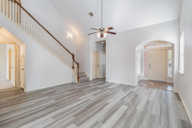 unfurnished living room featuring ceiling fan, light hardwood / wood-style flooring, and high vaulted ceiling