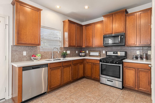 kitchen featuring tasteful backsplash, sink, and appliances with stainless steel finishes