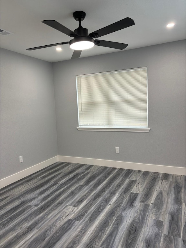 empty room with a wealth of natural light and dark wood-type flooring