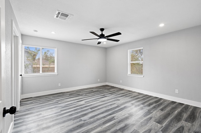 unfurnished room with hardwood / wood-style flooring, ceiling fan, and a healthy amount of sunlight