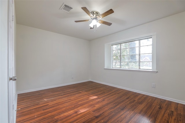 spare room with ceiling fan and dark wood-type flooring