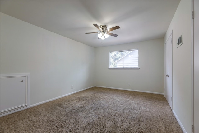 spare room featuring carpet flooring and ceiling fan