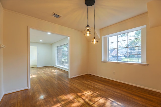 unfurnished dining area featuring dark hardwood / wood-style floors and crown molding