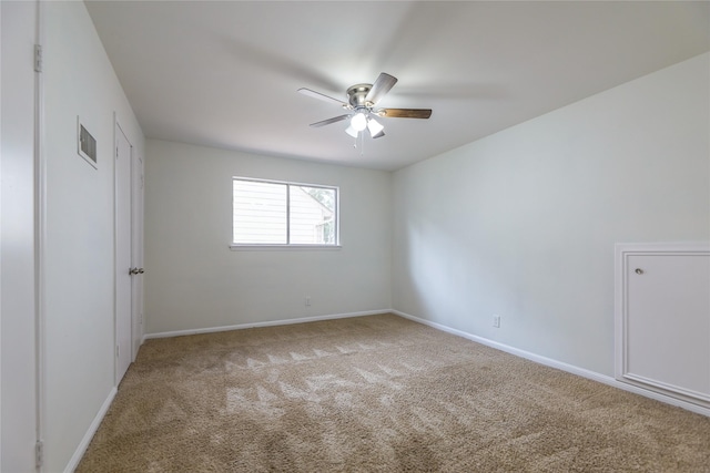 spare room with carpet and ceiling fan