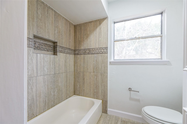 bathroom with a healthy amount of sunlight, toilet, and shower / washtub combination