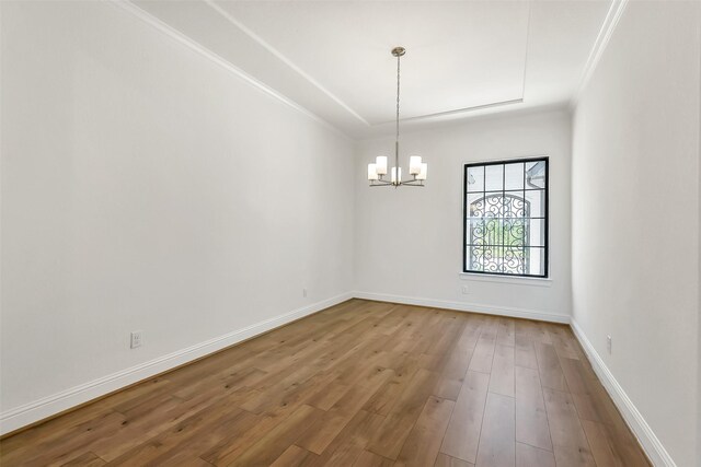 12926 Whitewater Way, Conroe, TX 77302 - empty room featuring a chandelier, wood finished floors, and ornamental molding