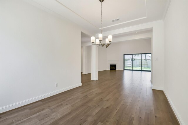 12926 Whitewater Way, Conroe, TX 77302 - unfurnished room with a chandelier, wood finished floors, and a fireplace