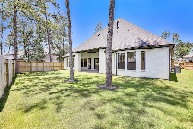 12926 Whitewater Way, Conroe, TX 77302 - back of house with a fenced backyard, a shingled roof, and brick siding
