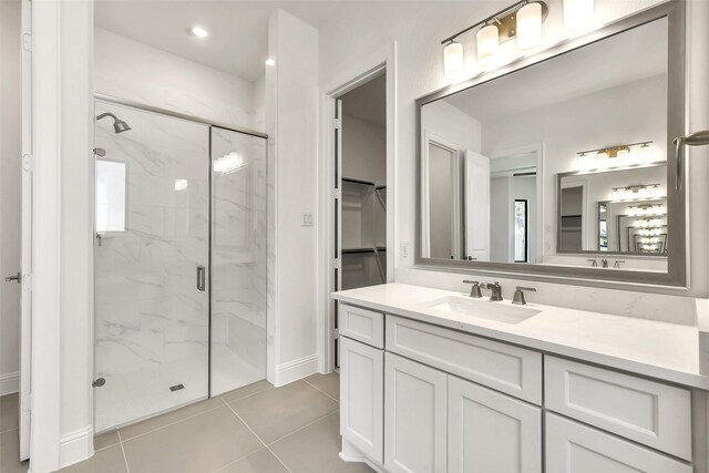 12926 Whitewater Way, Conroe, TX 77302 - full bath featuring a marble finish shower, vanity, tile patterned floors, and a walk in closet