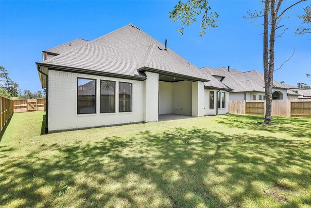 12926 Whitewater Way, Conroe, TX 77302 - rear view of house with a shingled roof, a fenced backyard, and brick siding
