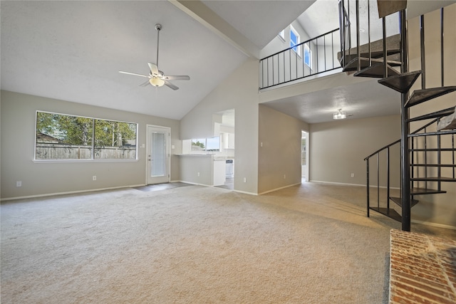 unfurnished living room with carpet floors, high vaulted ceiling, and ceiling fan