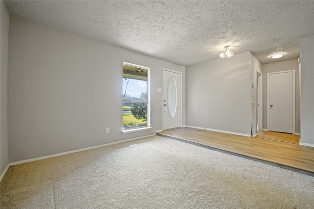 foyer with hardwood / wood-style floors and a textured ceiling