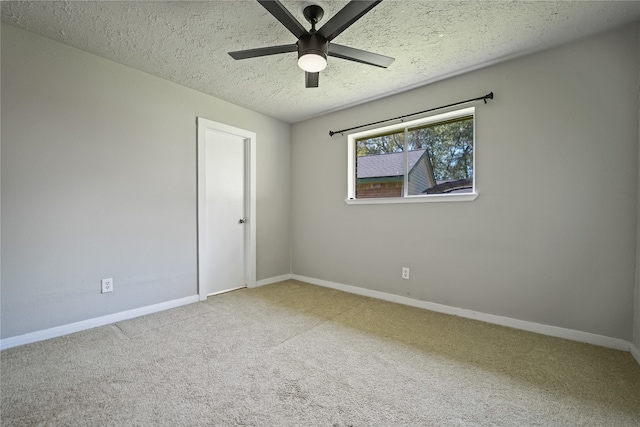 carpeted empty room with a textured ceiling and ceiling fan