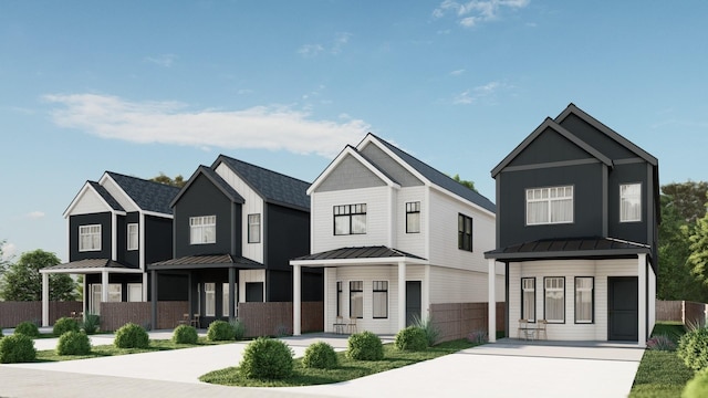 modern farmhouse with a porch, driveway, metal roof, and a standing seam roof