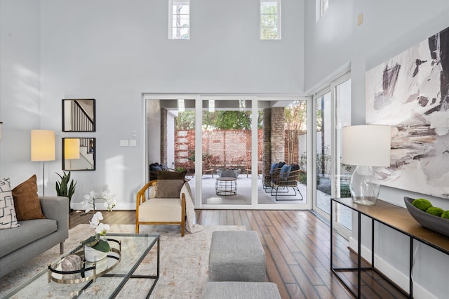 living room featuring hardwood / wood-style flooring and a high ceiling