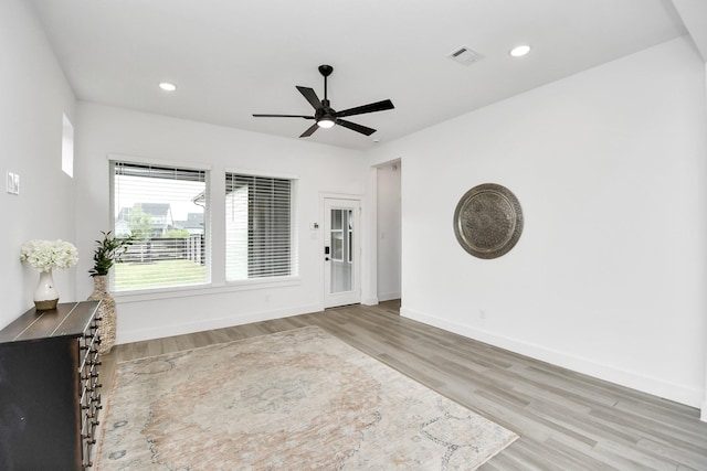 unfurnished living room with ceiling fan and light hardwood / wood-style flooring