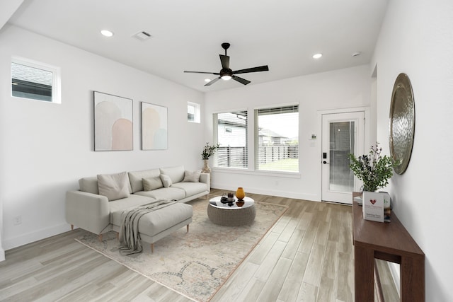 living room with ceiling fan and light hardwood / wood-style floors