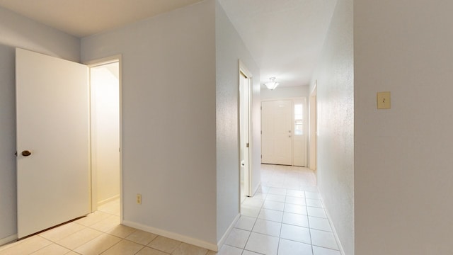 hall with light tile patterned floors