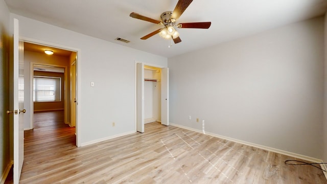 unfurnished bedroom with ceiling fan, a closet, and light hardwood / wood-style floors